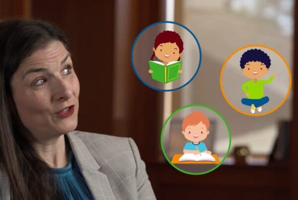 A still from Schenck School's Live Action/Mixed Media explainer video; Dr. Kara A Loftin is interviewed while small animations of children pop up in bubbles besides her